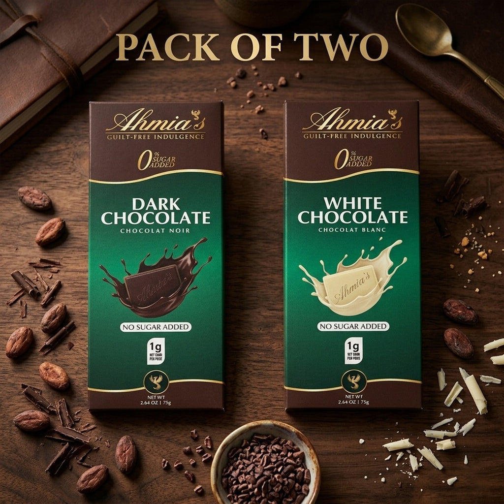 Two packs of Ahmia's no sugar added dark and white chocolate on a wooden surface with cocoa beans and a spoon.