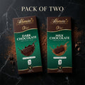 Two packs of Ahmia dark and milk chocolate on a dark marble background